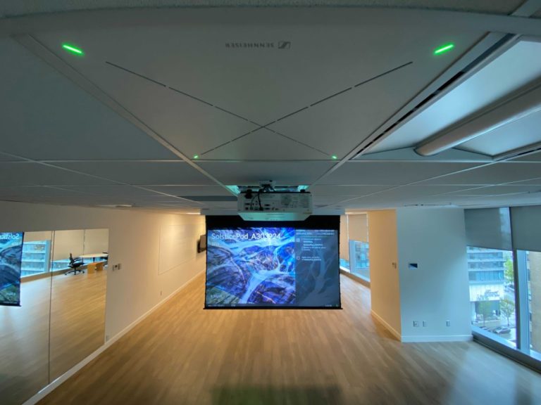 Meeting room with a drop-down projection screen and ceiling speakers