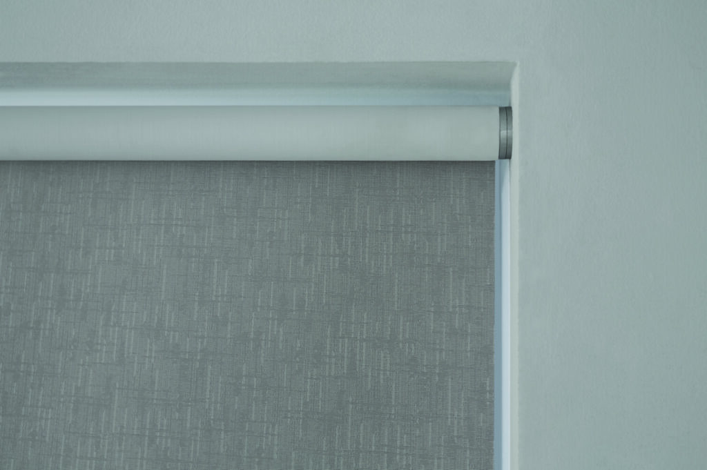 Close-up view of Lutron Roller Shades showcasing their sleek design, precision engineering, and premium fabric options, highlighting their seamless integration into smart home systems for optimal light control and energy efficiency.
