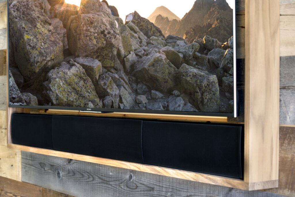 High-end, custom-fitted luxury soundbar perfectly sized for a large TV in a modern Vancouver home, delivering premium audio and clean design without visible clutter.