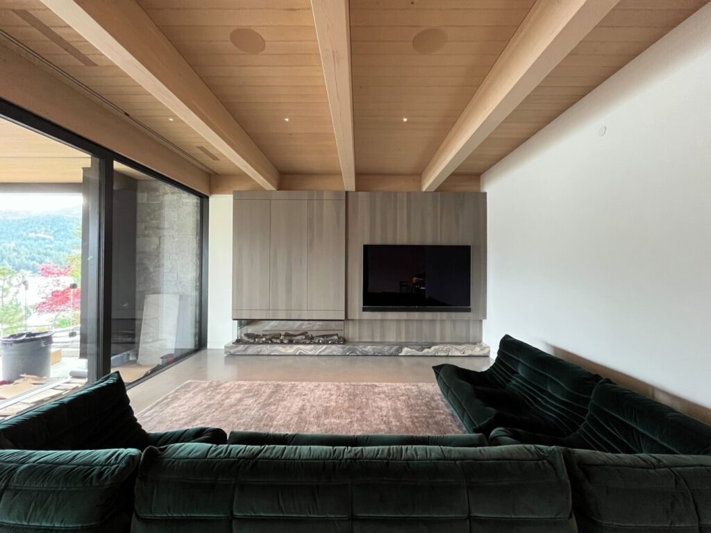 Living room in a Whistler home with a TV controlled by Control4, featuring seamless smart home automation