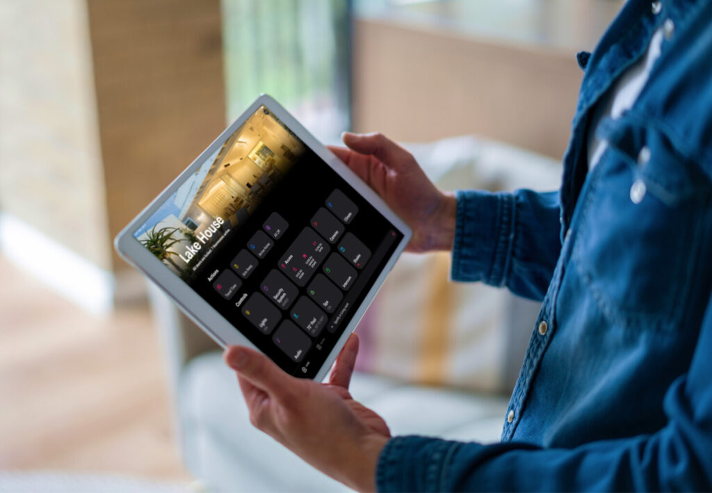 Crestron smart home app on tablet showing Lake House automation controls for lighting, climate and security — remote home control by Pure Image smart home automation BC