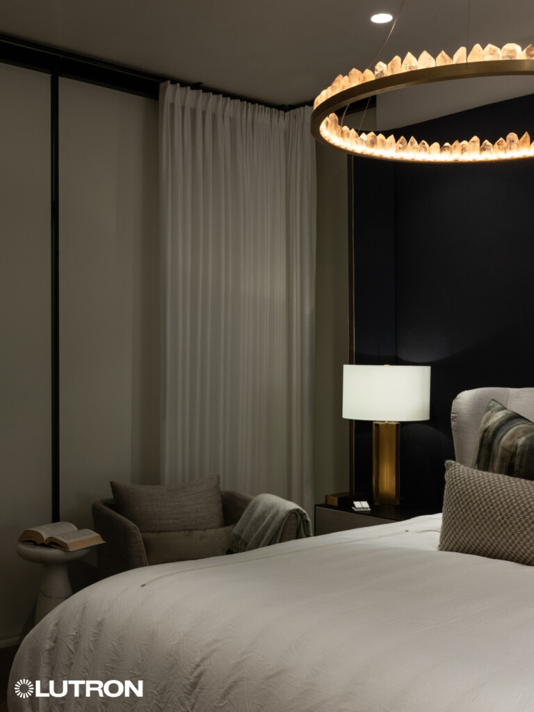 Stylish drapery paired with Lutron shades in the bedroom, offering a perfect balance of privacy, light control, and elegance. The combination of luxurious fabrics and advanced automation creates a serene, comfortable environment for rest and relaxation.