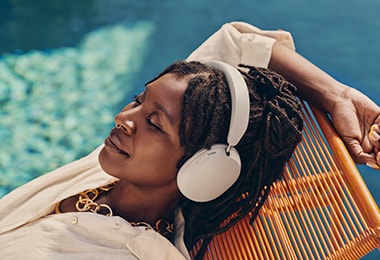 Woman enjoying a Sonos sound system on the deck of a luxury superyacht for premium audio experience