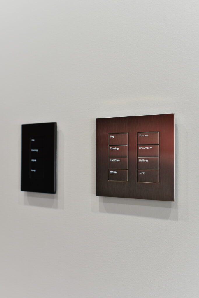 Lutron keypads provide elegant, tactile control over the home theatre system in the Pure Image showroom, allowing effortless adjustment of lighting, shades, and audio scenes. These beautifully designed controls blend seamlessly into the space, enhancing both convenience and ambiance.