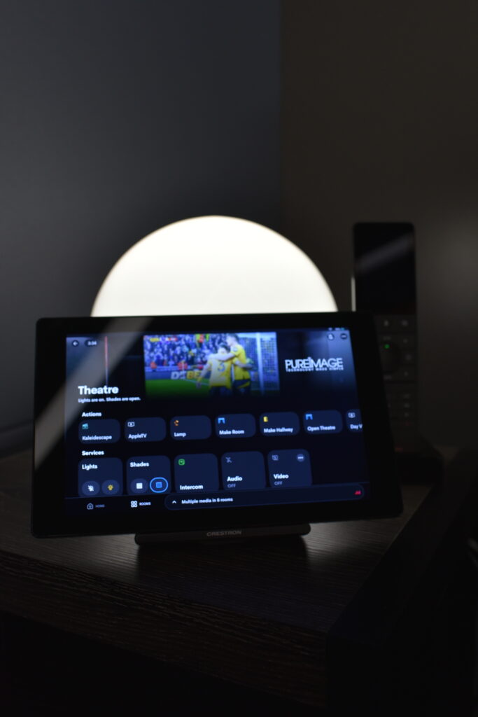 Crestron touchscreen and wall keypads in the Pure Image Vancouver showroom provide seamless control of audio, video, lighting, and shading—offering intuitive smart home automation and an elevated cinematic experience.