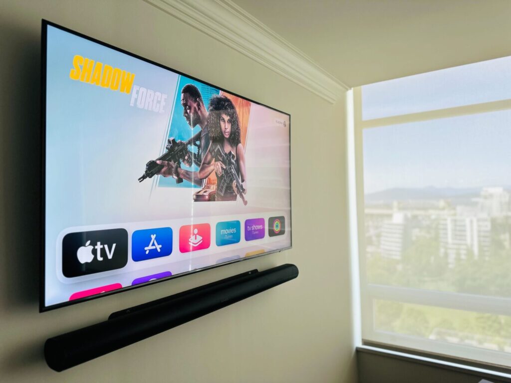  wall-mounted TV paired with a Sonos soundbar, expertly installed by Pure Image. The setup offers a sleek, cable-free look with powerful, room-filling audio—all controlled effortlessly through the Sonos app or a smart remote. It’s the perfect blend of clean design and everyday functionality.

