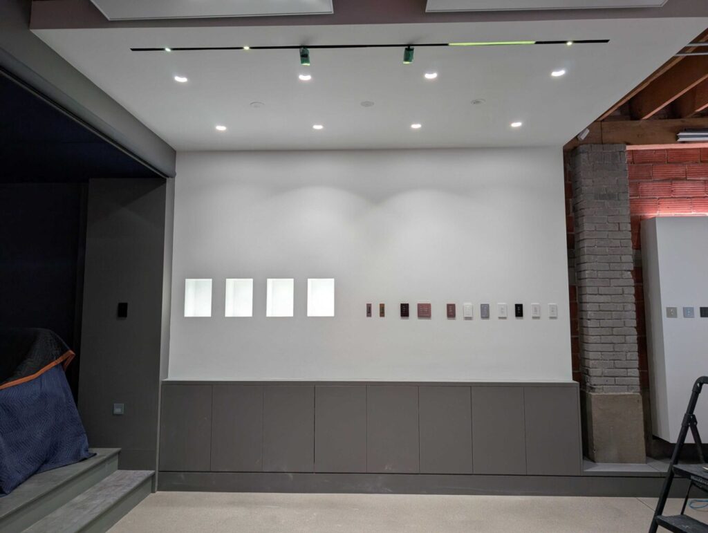 The ceiling is fully installed and freshly painted—ready to showcase the stunning Ketra D2 and Rania downlights. This clean, seamless canvas highlights the sleek design and natural light quality of the fixtures, setting the stage for an immersive lighting experience in the Pure Image showroom.