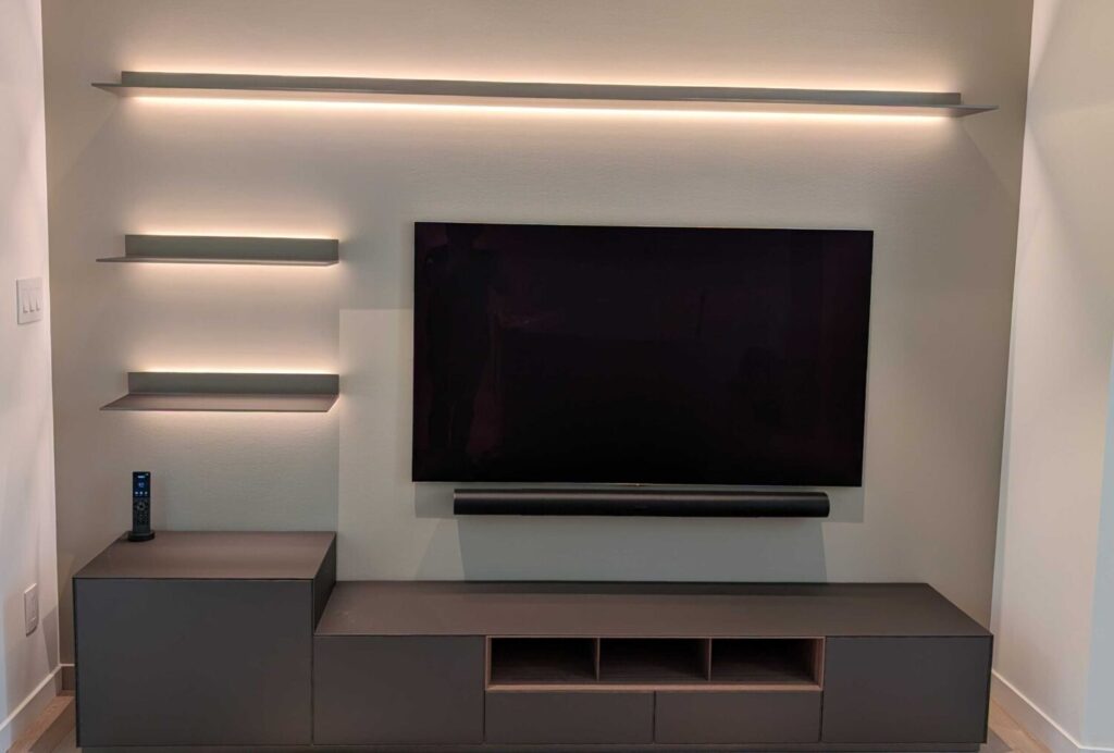  wall-mounted TV paired with a Sonos soundbar, expertly installed by Pure Image. The setup offers a sleek, cable-free look with powerful, room-filling audio—all controlled effortlessly through the Sonos app or a smart remote. It’s the perfect blend of clean design and everyday functionality.

