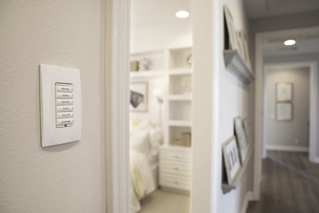 Elegant Control4 smart keypad integrated into a contemporary wall, enabling homeowners to manage lighting, media, and automated home scenes effortlessly.