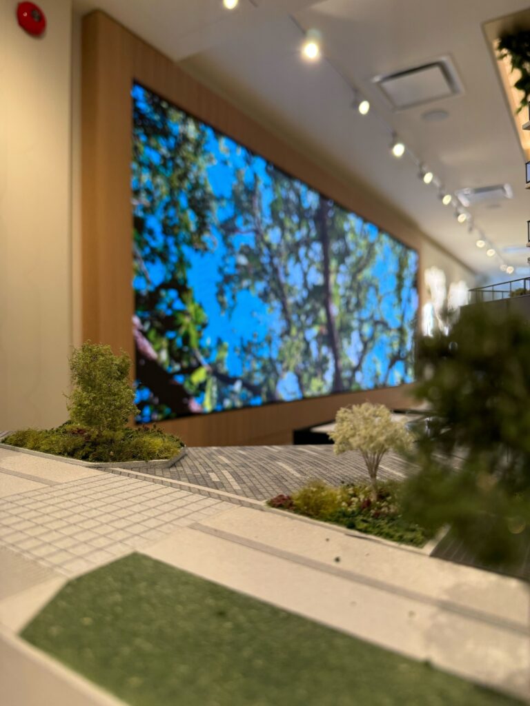 Close-up view of a luxury Vancouver video wall installation by Pure Image, featuring a high-resolution LED display behind an architectural model in a real estate sales center.