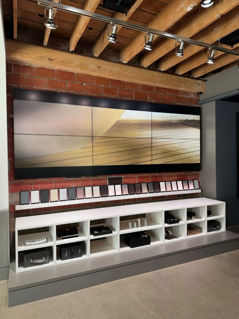Pure Image Vancouver showroom featuring a large format video wall display, Lutron motorized shade fabric sample wall, keypad and lighting control samples — experience smart home technology in person at our Vancouver showroom