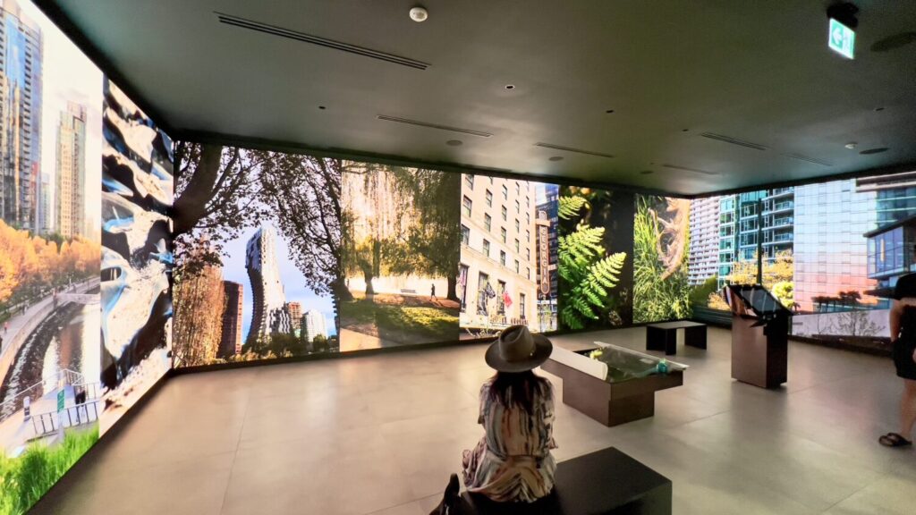 Immersive Vancouver video wall installation by Pure Image, featuring a floor-to-ceiling LED display wrapping around the room with vivid cityscape visuals and modern interior design.