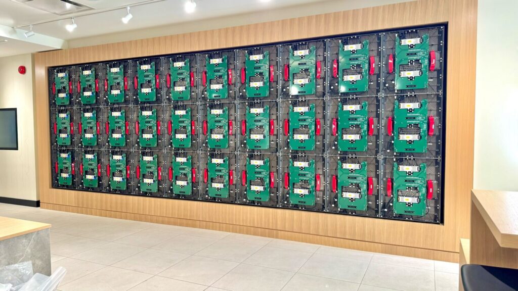 Detailed view of a Planar video wall being built, highlighting the precise placement of each block for a flawless final installation