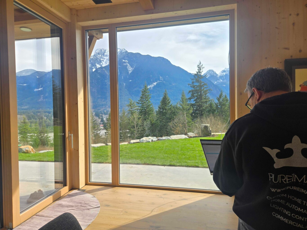 Pure Image Technician working on site overlooking a beautiful view of the Whistler Mountain