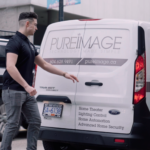 Pure Image technician preparing for smart home service visit with branded van in Vancouver