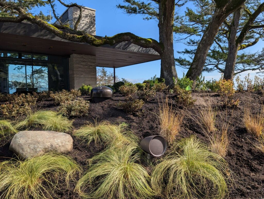 Sonance Landscape Speakers in a beautiful garden on Vancouver Island House designed and installed by smart home automation company Pure Image