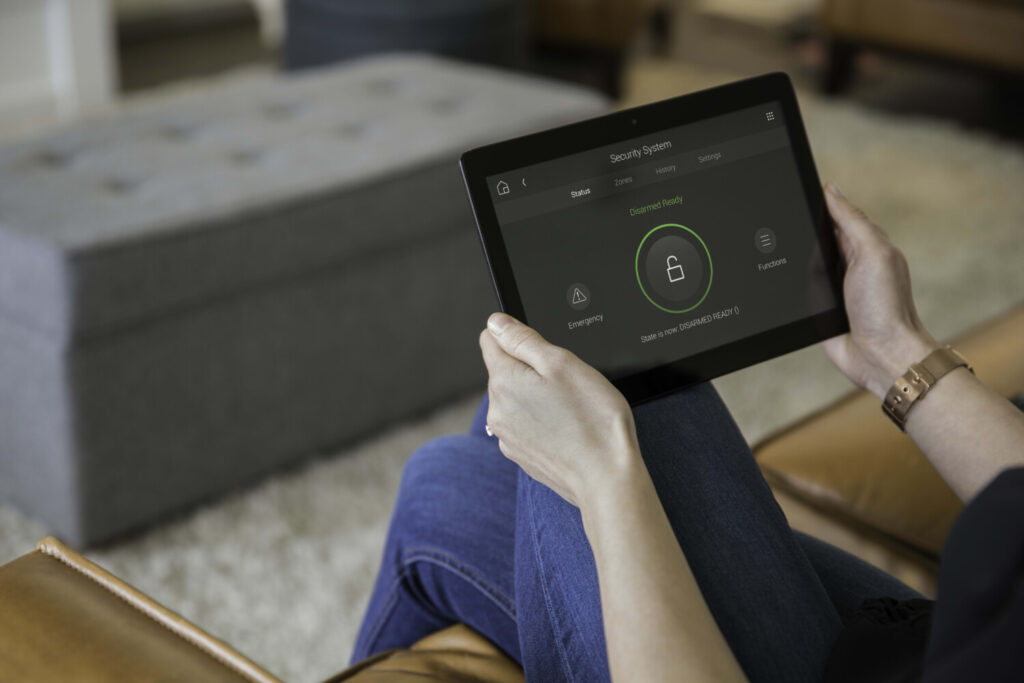 Control4 smart home security system app on tablet showing disarmed status — home security control and smart home automation installation by Pure Image Calgary