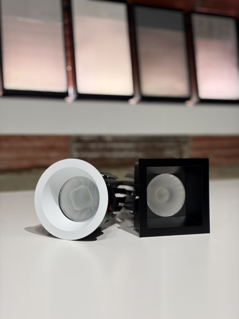 Ketra D2R square and round remodeler downlights on display at Pure Image Vancouver showroom alongside Lutron motorized shade fabric samples — Ketra retrofit lighting installation Vancouver BC
