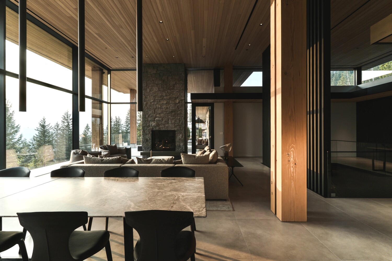Timber-lined living space at Revy House in Revelstoke, with integrated lighting and full-height glazing