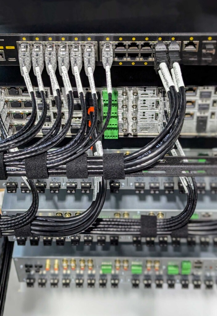Close-up of professionally managed network switches and structured cabling in a Pure Image smart home rack in Vancouver residence.