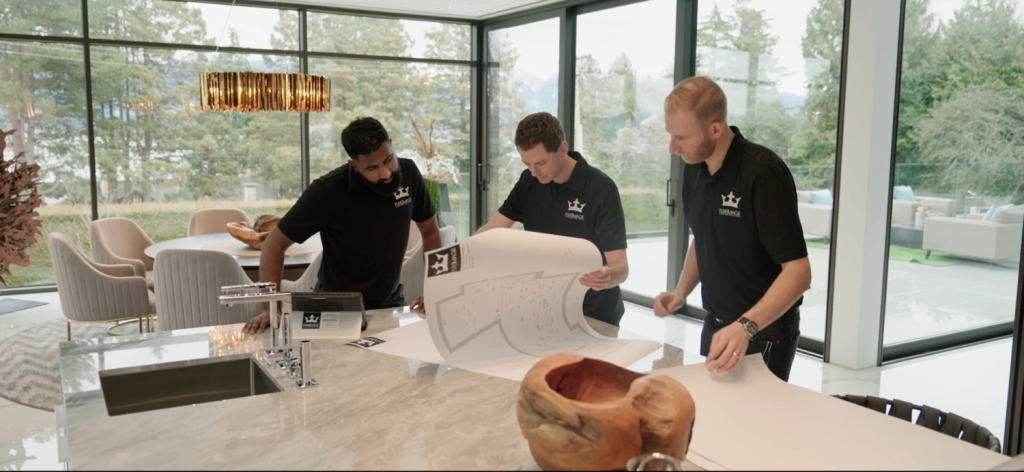 ure Image home theatre design and installation team reviewing plans in luxury Vancouver home — custom home theatre design installation and project management by Pure Image BC