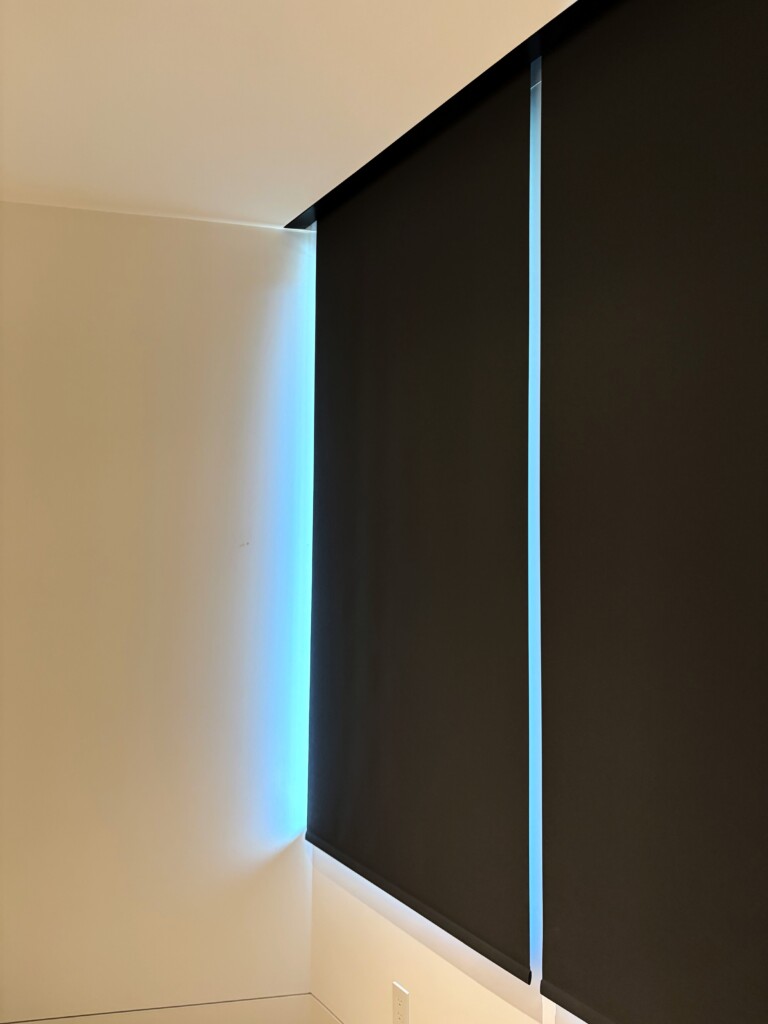 Motorized Lutron blackout shades in a private residence in Whistler, installed by Pure Image for privacy, full room darkening, and energy efficiency.