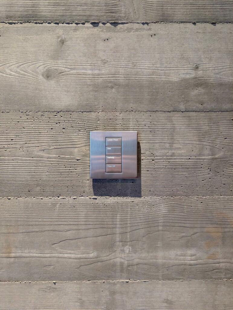 Lutron Palladiom keypad mounted on a wall, showing the slim profile and custom engraving installer by Pure Image team.